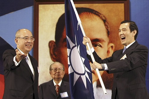 Taiwan President Ma waves the party flag as outgoing KMT Chairman Wu smiles during the KMT's national congress in Taipei